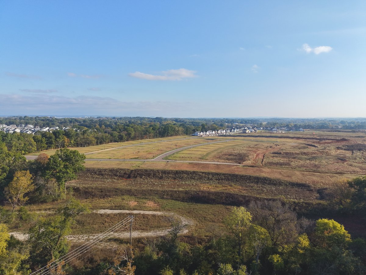 Wide aerial view of new streets and graded lots in Maury County, Tennessee.